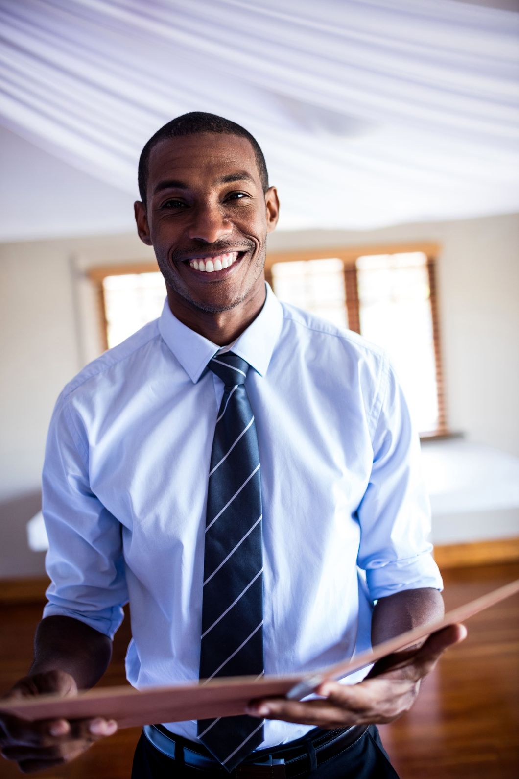 male supervisor standing with a file in hotel vklzkuk 1.jpg